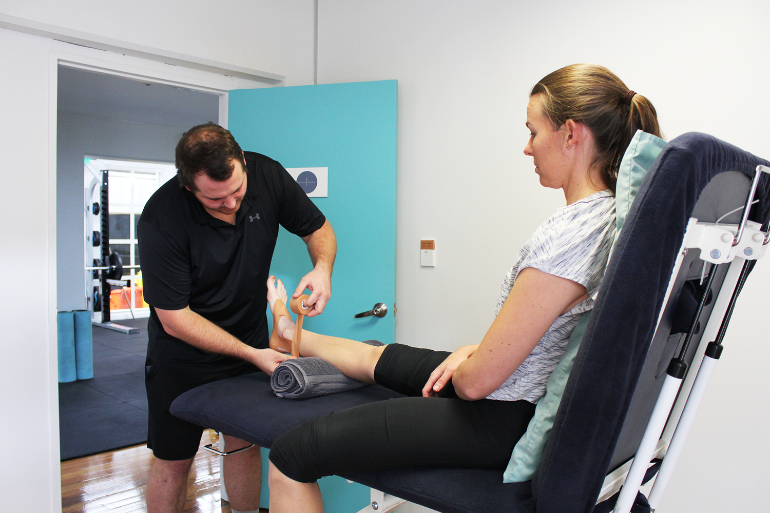 A physiotherapist performing acupuncture treatment at Physio Impact